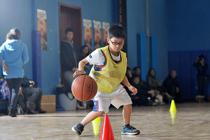 小学员在练习篮球技巧